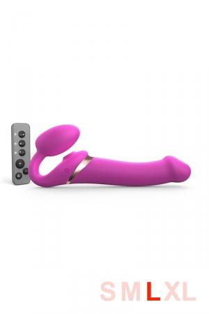 Nouvelle édition du gode-ceinture anatomique  Strap-On-Me vibrant,  doté d'une langue vibrante pour le clitoris. fuchsia, taille L.