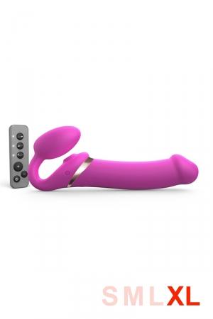 nouvelle édition du gode-ceinture anatomique  Strap-On-Me vibrant,  doté d'une langue vibrante pour le clitoris. Fuschia, taille XL.