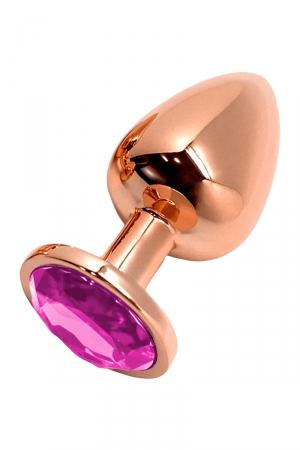 Plug anal en métal couleur rose gold dune longueur de 9 cm et dun diamètre de 4 cm, décoré dun bijou rose à sa base.