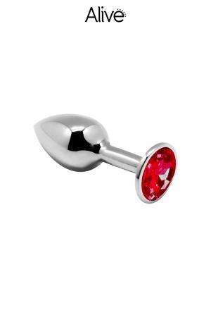 Plug anal en métal dune longueur de 7 cm et un diamètre de 3,4 cm décoré d'un strass rouge.